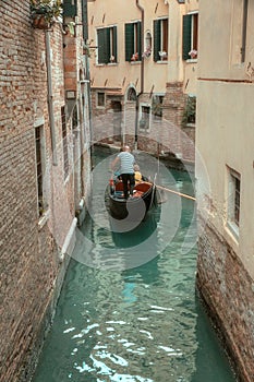 gondolier sailing on a canal in venice