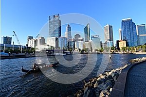 Gondolla boat sailing into Elizabeth Quay in Perth at sunset