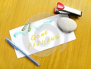 Gone Fishing note on desk