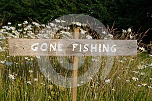 Gone Fishing sign among flowers