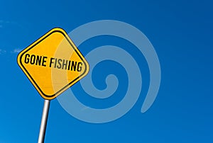 gone fishing - yellow sign with blue sky