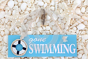 Gone Swimming Sign on Seashells