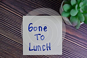 Gone To Lunch write on sticky notes isolated on Wooden Table