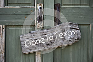 Gone to Texas sign on door photo