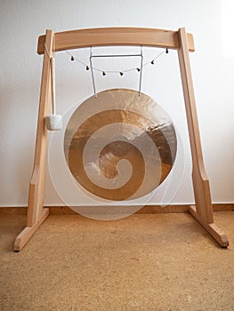 Gong in a wooden stand for sound healing ceremony