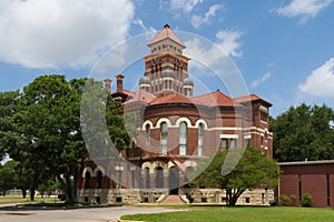 The Gonzales County Courthouse is cruciform in plan with four se photo