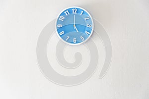 Good afternoon or after midnight with 5:00 clock on white concrete wall interior background with copy space, message board