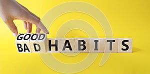 Good and bad Habits symbol. Businessman hand Turnes wooden cubes and changes words Bad Habits to Good Habits. Beautiful yellow