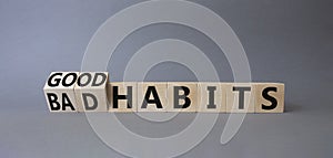 Good and bad Habits symbol. Turned wooden cubes with words Bad Habits and Good Habits. Beautiful grey background. Medicine concept