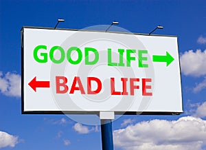 Good or bad life symbol. Concept word Good life Bad life on beautiful billboard with two arrows. Beautiful blue sky with clouds