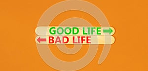 Good or bad life symbol. Concept word Good life Bad life on beautiful wooden stick. Beautiful orange table orange background.