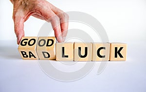 Good or bad luck symbol. Businessman turns wooden cubes and changes words `bad luck` to `good luck`. Beautiful white backgroun