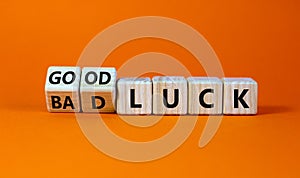 Good or bad luck symbol. Turned wooden cubes and changed words `bad luck` to `good luck`. Beautiful orange background, copy sp