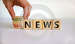 Good or bad news. Hand flips a cube and changes the words `bad news` to `good news`. Beautiful white background. Business conc