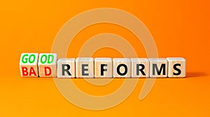 Good or bad reforms symbol. Concept words Good reforms Bad reforms on beautiful wooden blocks. Beautiful orange table orange