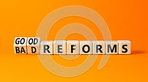 Good or bad reforms symbol. Concept words Good reforms Bad reforms on beautiful wooden blocks. Beautiful orange table orange