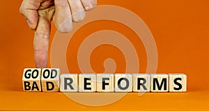 Good or bad reforms symbol. Concept words Good reforms Bad reforms on beautiful wooden blocks. Beautiful orange table orange