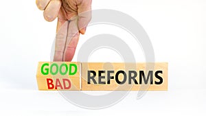 Good or bad reforms symbol. Concept words Good reforms Bad reforms on beautiful wooden blocks. Beautiful white table white