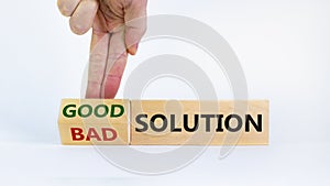 Good or bad solution concept. Businessman turns a block and changes words `bad solution` to `good solution`. Beautiful white