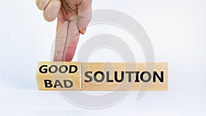 Good or bad solution concept. Businessman turns a block and changes words `bad solution` to `good solution`. Beautiful white