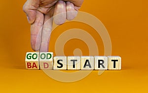 Good or bad start symbol. Businessman turns wooden cubes and changes words `bad start` to `good start`. Beautiful orange table