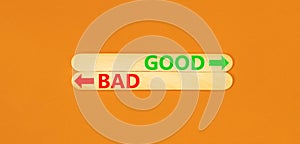 Good or bad symbol. Concept word Good or Bad on beautiful wooden stick. Beautiful orange table orange background. Business and