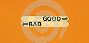 Good or bad symbol. Concept word Good or Bad on beautiful wooden stick. Beautiful orange table orange background. Business and