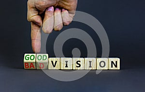 Good or bad vision symbol. Businessman turns cubes and changes words `bad vision` to `good vision`. Beautiful grey table, grey