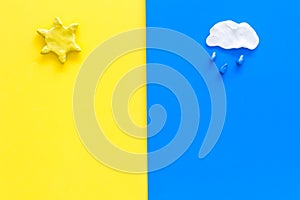 Good and bad weather concept. Template for forecast. Sun vs rainy cloud on yellow and blue background top view copy