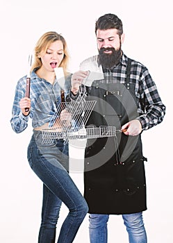 Good for barbecue. Bearded man and pretty woman holding grilling grate. Happy couple having grill grid for grilling