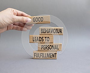 Good behaviour leads to personal fulfillment symbol. Business Concept words Good behaviour leads to personal fulfillment on wooden