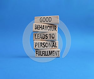 Good behaviour leads to personal fulfillment symbol. Concept words Good behaviour leads to personal fulfillment on wooden blocks.