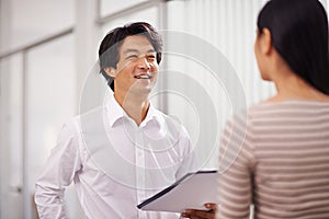 Good business relationships in the workplace is key. two business professionals discussing work in the office.