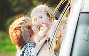 Good bye before car travel. Cute children saying goodbye before car travel.