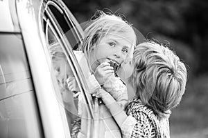 Good bye before car travel. Cute children saying goodbye before car travel.