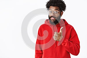 That is good content. Portrait of satisfied good-looking african american music producer with beard in glasses and red