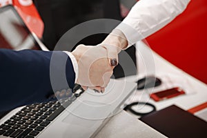 Good deal. Close-up shoot of the hands shaking in front of the car photo