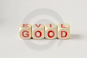 Good and Evil written with wooden cubes