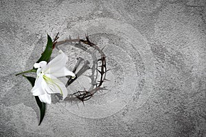 Good Friday, Passion of Jesus Christ. Crown of thorns, nails and white lily on grey background. Christian Easter holiday