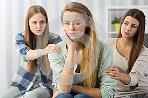 Good friends cheering worried teenager