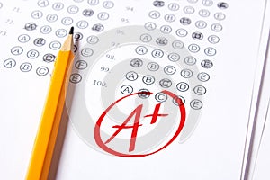 Good grade of A plus is written with red pen on the tests.