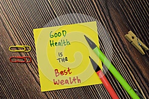 Good Health is the Best Wealth write on sticky note isolated on Wooden Table. Motivation or Financial Concept