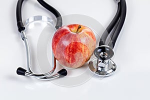 Good health with fresh red apple and stethoscope