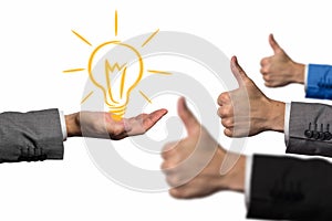 Good idea concept. Hand holding a lightbulb while other hands showing thumbs up hand sign. Businessman idea concept