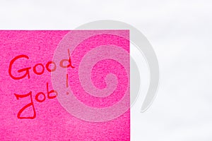 Good job handwriting text close up isolated on pink paper with copy space. Writing text on memo post reminder