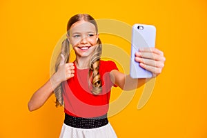 Good job. Photo of pretty small lady holding telephone making selfies raising thumb finger up for blog wear casual red