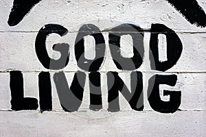 Good living spelled out on white concrete background