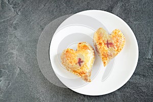 Good lookind heart shape cakes on white plate with red towel and