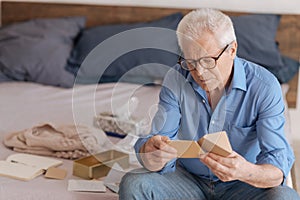 Good looking aged man reading a note