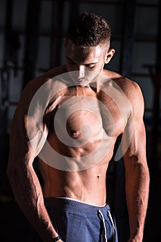 Good-looking athletic young man in gym